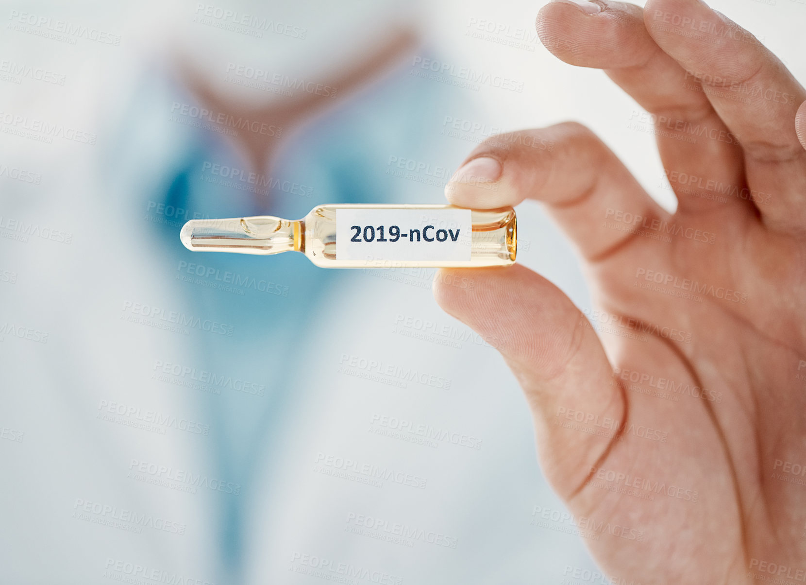 Buy stock photo Cropped shot of a scientist holding an ampoule with 2019-nCov on it