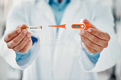Buy stock photo Cropped shot of a scientist holding an ampoule with 2019-nCov on it and a thermometer