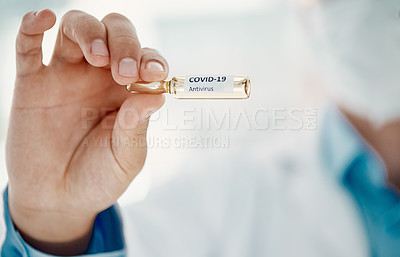 Buy stock photo Cropped shot of a scientist holding an ampoule with 2019-nCov on it