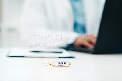 Buy stock photo Cropped shot of a scientist using a laptop while working on a coronavirus cure in a laboratory