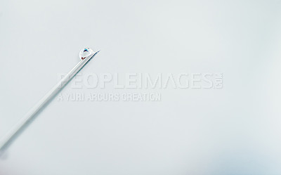 Buy stock photo Shot of a surgical needle with medication dripping from it