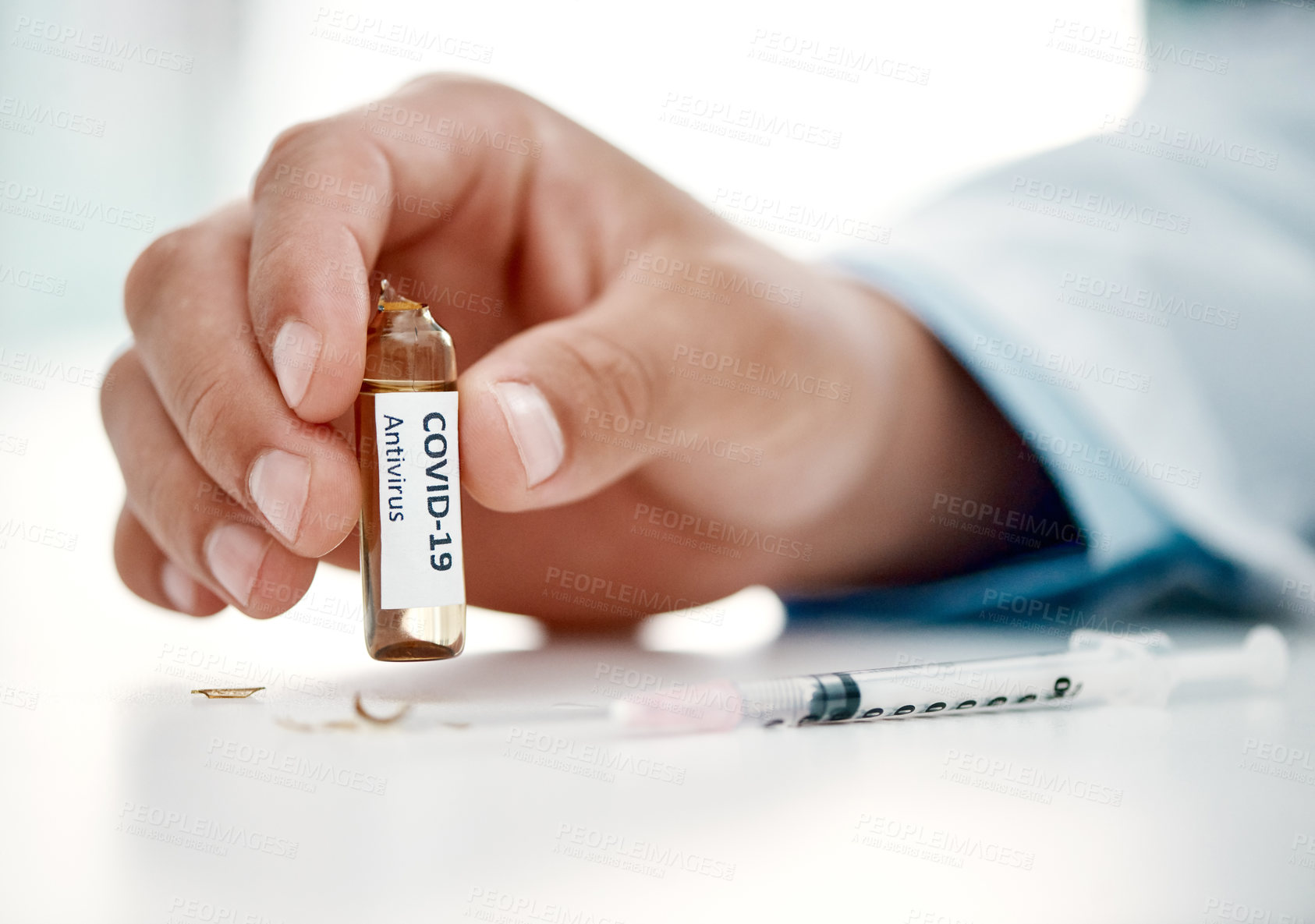 Buy stock photo Cropped shot of a scientist holding an ampoule with 2019-nCov on it