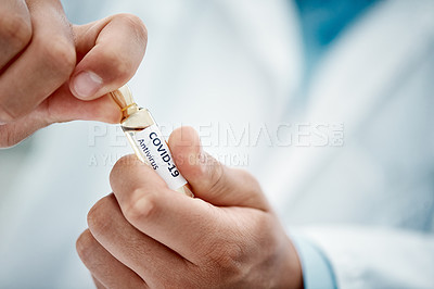 Buy stock photo Cropped shot of a scientist opening an ampoule with 2019-nCov on it