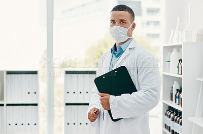 Buy stock photo Portrait of a confident young scientist wearing a mask in a modern laboratory