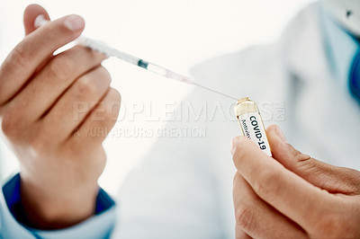 Buy stock photo Shot of a scientist extracting medication using a syringe from an ampoule with 2019-nCov on it
