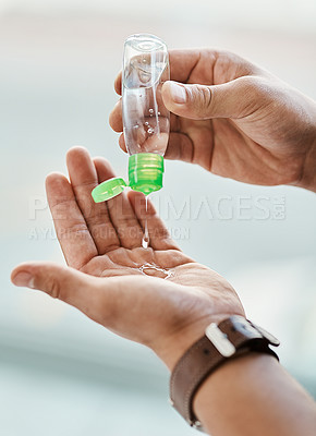 Buy stock photo Cropped shot of a man using hand sanitiser to disinfect his hands