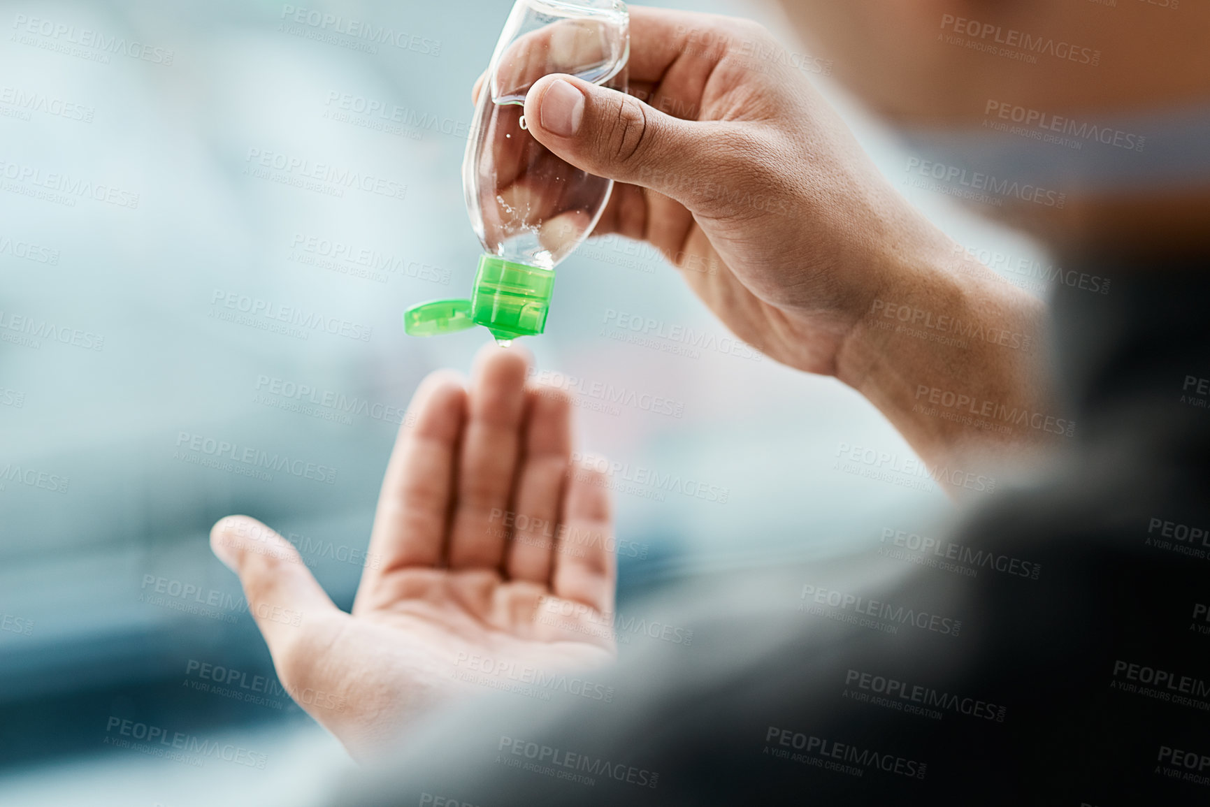 Buy stock photo Cropped shot of a businessman using hand sanitiser to disinfect his hands