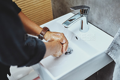 Buy stock photo Cropped shot of an unrecognisable man washing his hands in the bathroom sink