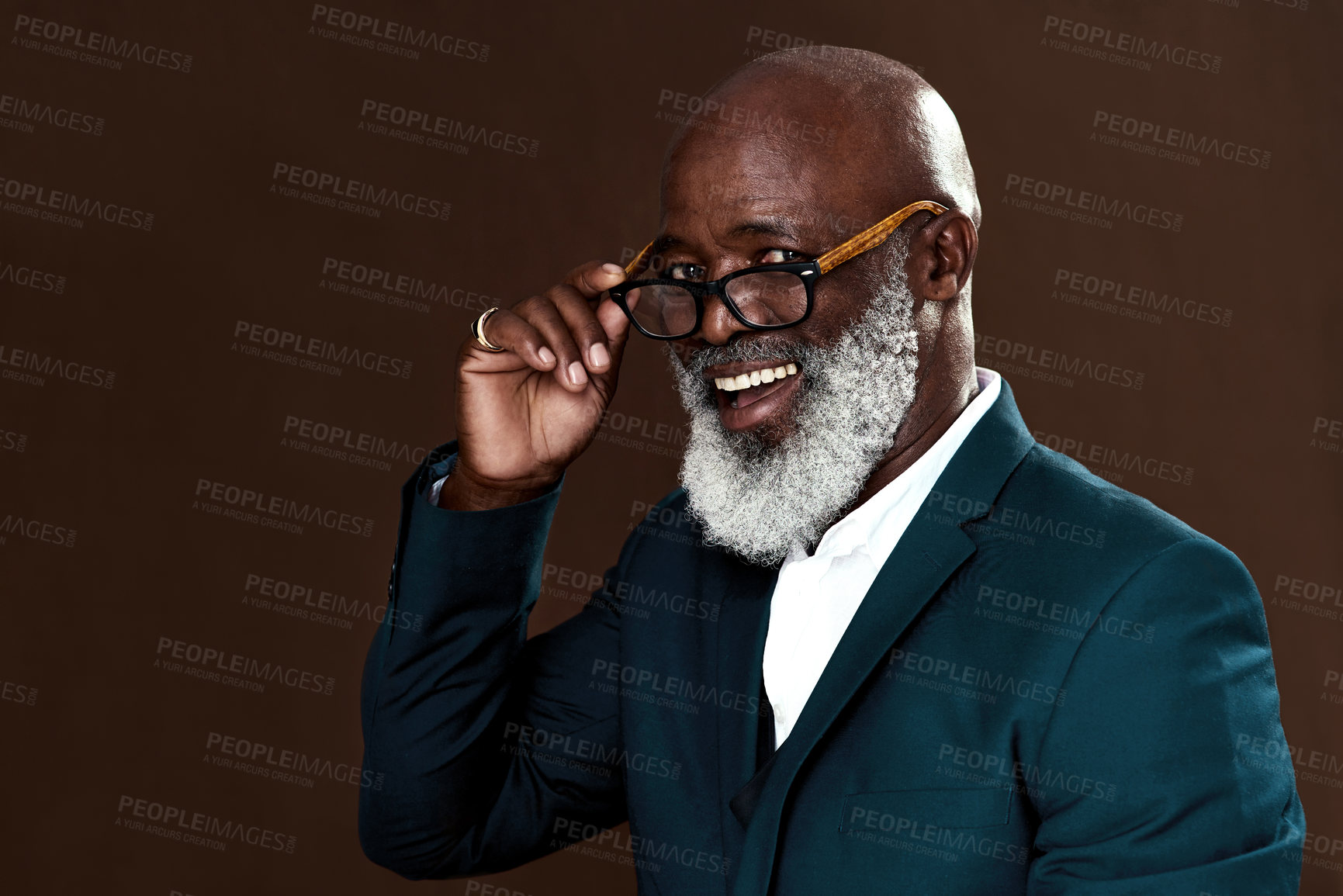 Buy stock photo Studio shot of a mature businessman posing against a brown background