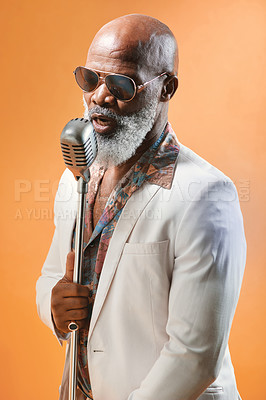 Buy stock photo Singer, senior and black man with soul, jazz and old school music with retro style and microphone in studio. Musician, cool and singing with sunglasses in groovy fashion and colorful background