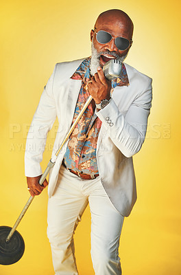 Buy stock photo Studio shot of a senior man wearing vintage clothes while singing into a microphone