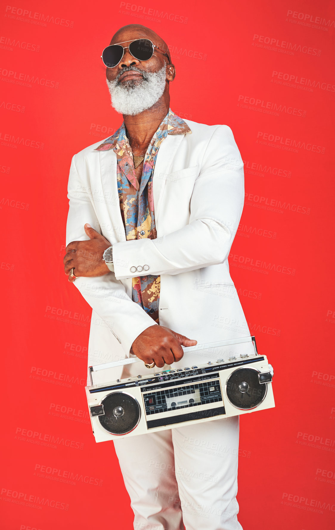 Buy stock photo Mature, man and radio in vintage fashion with confidence, sunglasses or trendy outfit in studio. Retro aesthetic, black person and hipster style on red background with boombox for soul music or audio