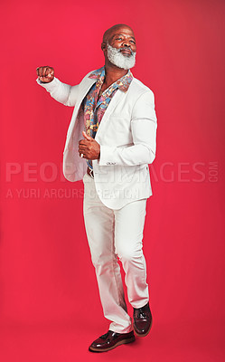 Buy stock photo Studio shot of a man wearing vintage clothes while dancing against a red background
