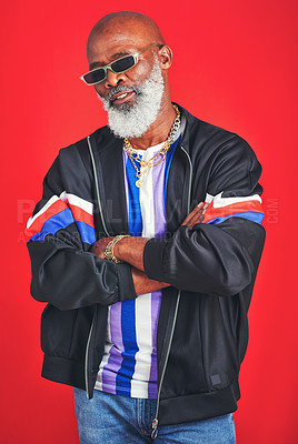 Buy stock photo Studio shot of a senior man wearing retro attire while posing against a red background