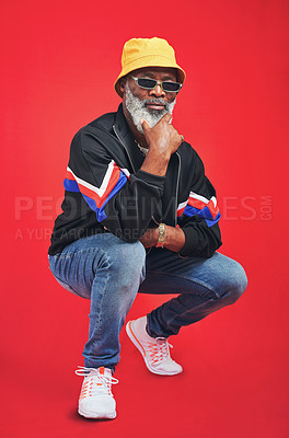 Buy stock photo Mature man, fashion and confident as retro for trendy outfit, casual or pride on red background. Male person, African and accessory for cool, clothes and style with attitude or sunglasses as designer