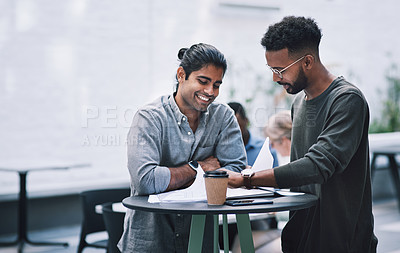 Buy stock photo Shot of two young businessmen having a meeting at a conference