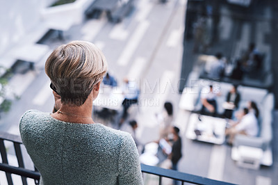 Buy stock photo Rearview shot of a mature businesswoman using a smartphone on the stairs of a modern office
