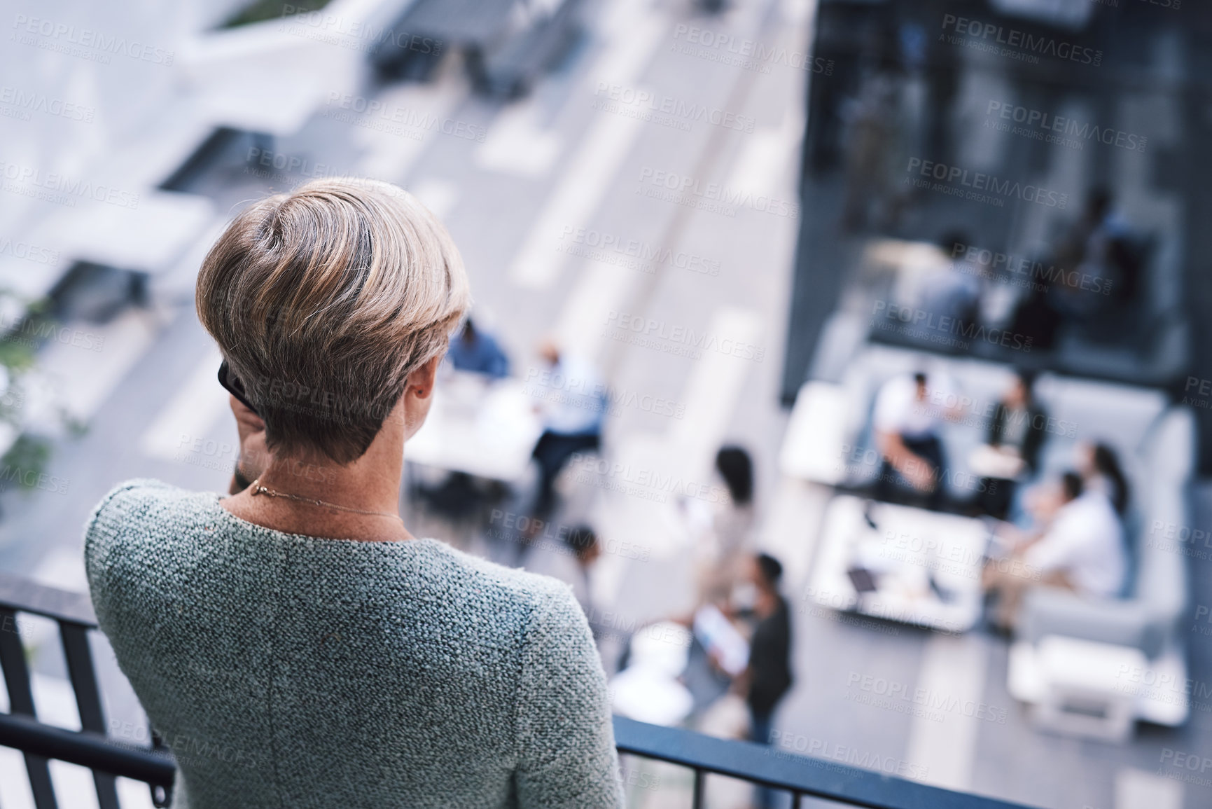 Buy stock photo Rearview shot of a mature businesswoman using a smartphone on the stairs of a modern office