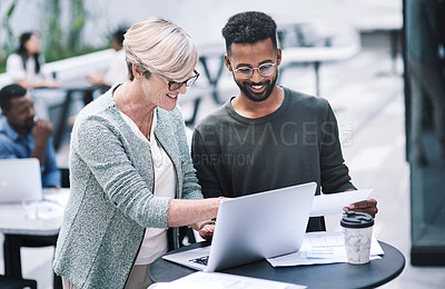Buy stock photo Shot of a businessman and businesswoman using a laptop during a meeting at a convention centre