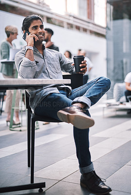 Buy stock photo Shot of a young businessman using a smartphone at a conference