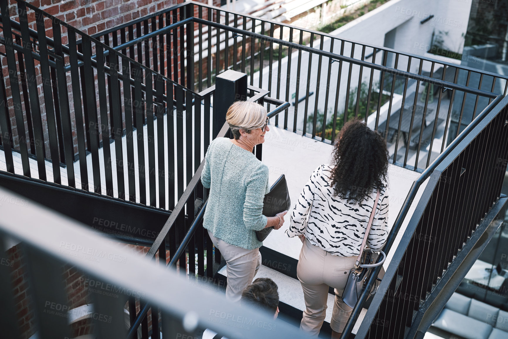 Buy stock photo Talking, stairs and business people outside office for discussion, plan and travel to real estate job. Realtor, women and professional friends on steps with chat, drink and morning commute from above