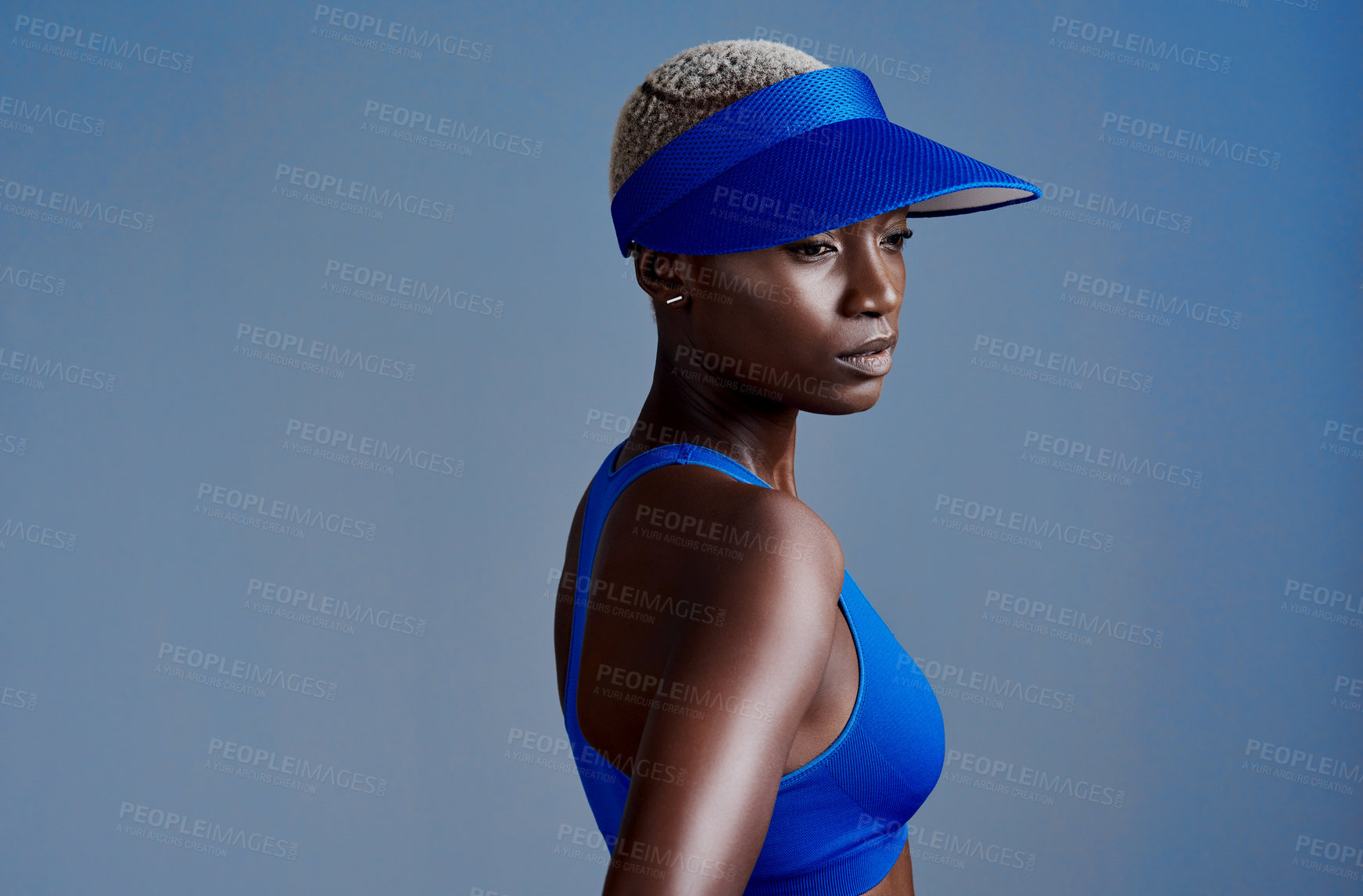 Buy stock photo Tennis, cap and black woman with sports in studio for fitness, competition and training at game. African person, serious and thinking with visor by blue background for exercise, workout and practice