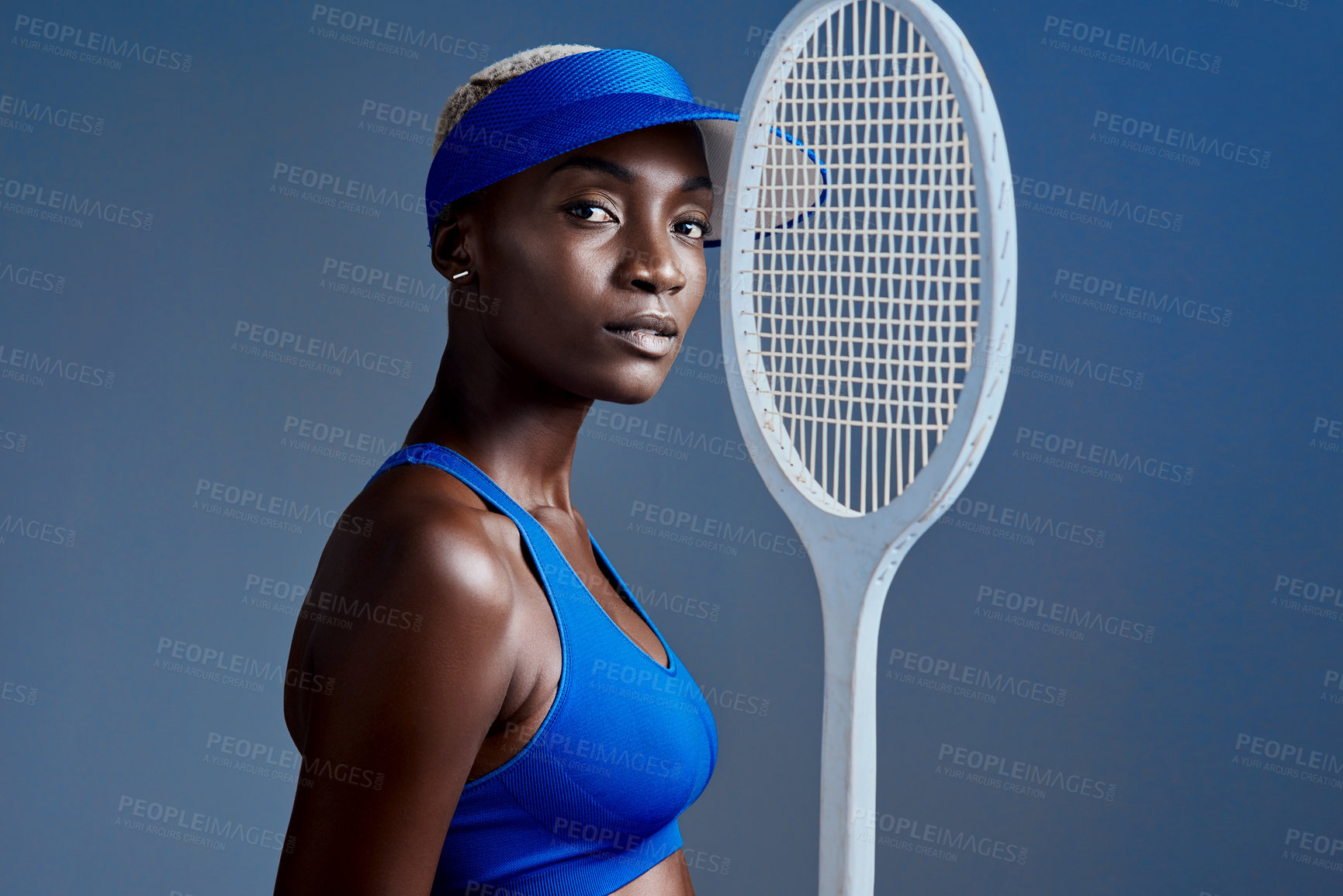 Buy stock photo Racket, fashion and black woman in studio for tennis training, workout or match with athlete. Portrait, style and African female sports player with confidence for game practice by blue background.