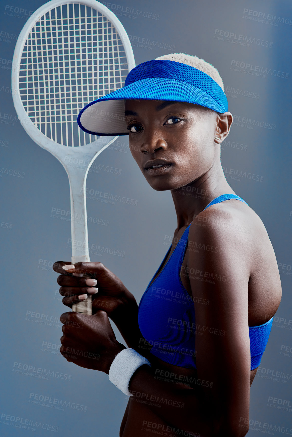 Buy stock photo Black woman, portrait and player with racket for tennis, sports or match on a studio background. Young African, female person or athlete with bat, hat or fashion for friendly competition or challenge