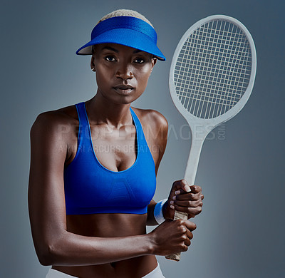 Buy stock photo Fitness, portrait and black woman with tennis racket in studio for competition, training and practice. African person, serious and visor with equipment for sports, workout and game by blue background