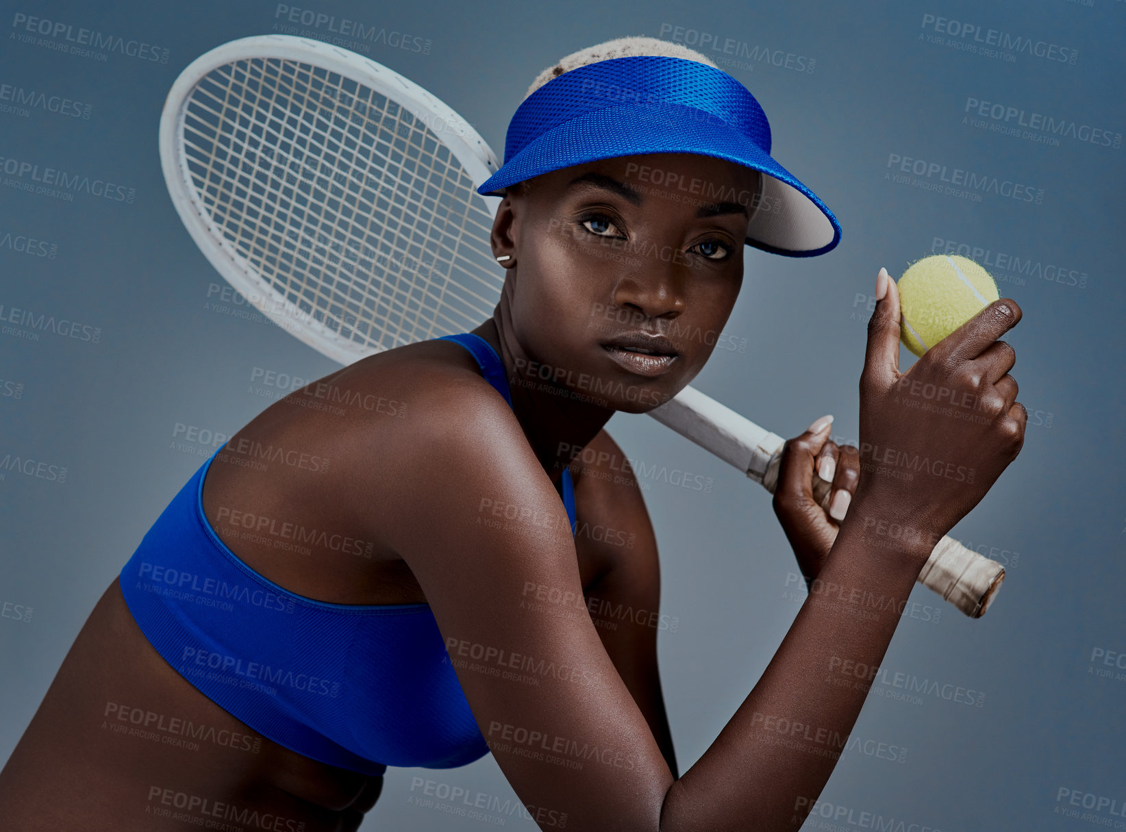 Buy stock photo Black woman, portrait and tennis ball in studio, sports racket and practice on blue background. Female person, athlete and equipment for exercise or tournament, training and workout for competition