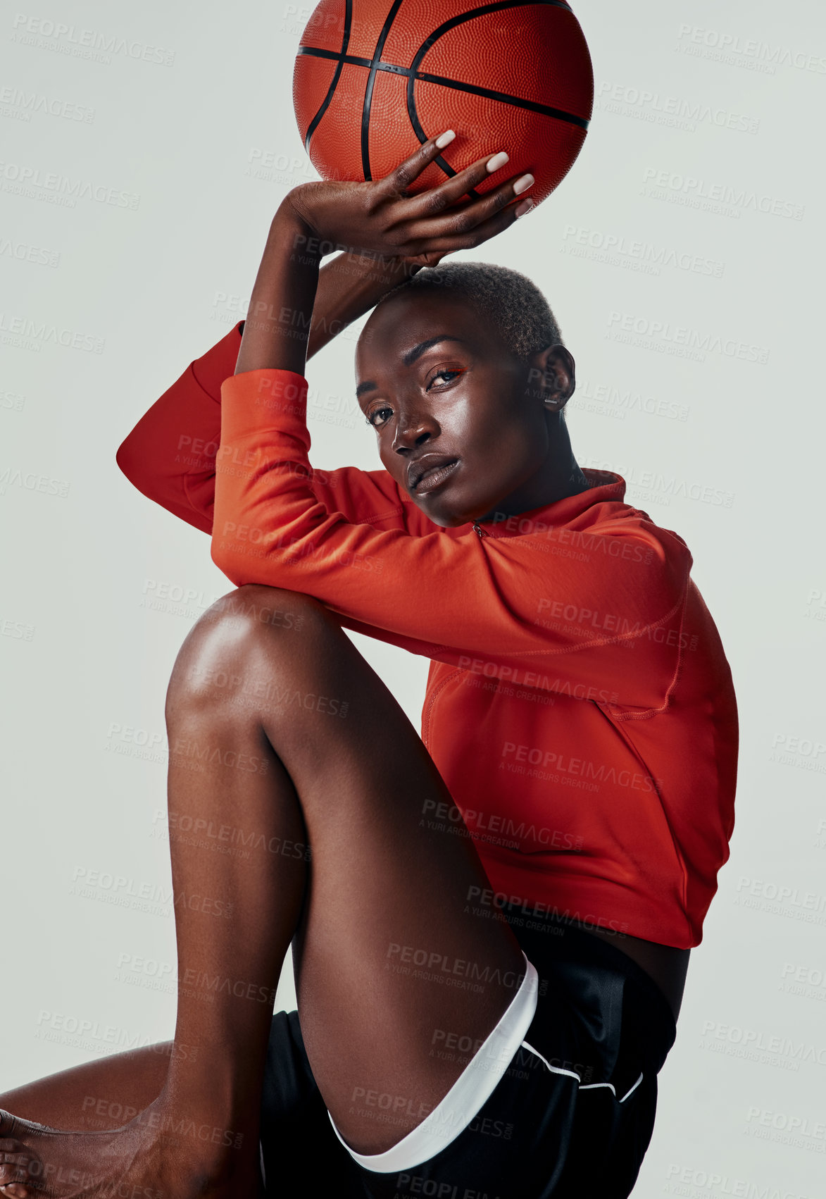 Buy stock photo Studio shot of an attractive young woman playing basketball against a grey background