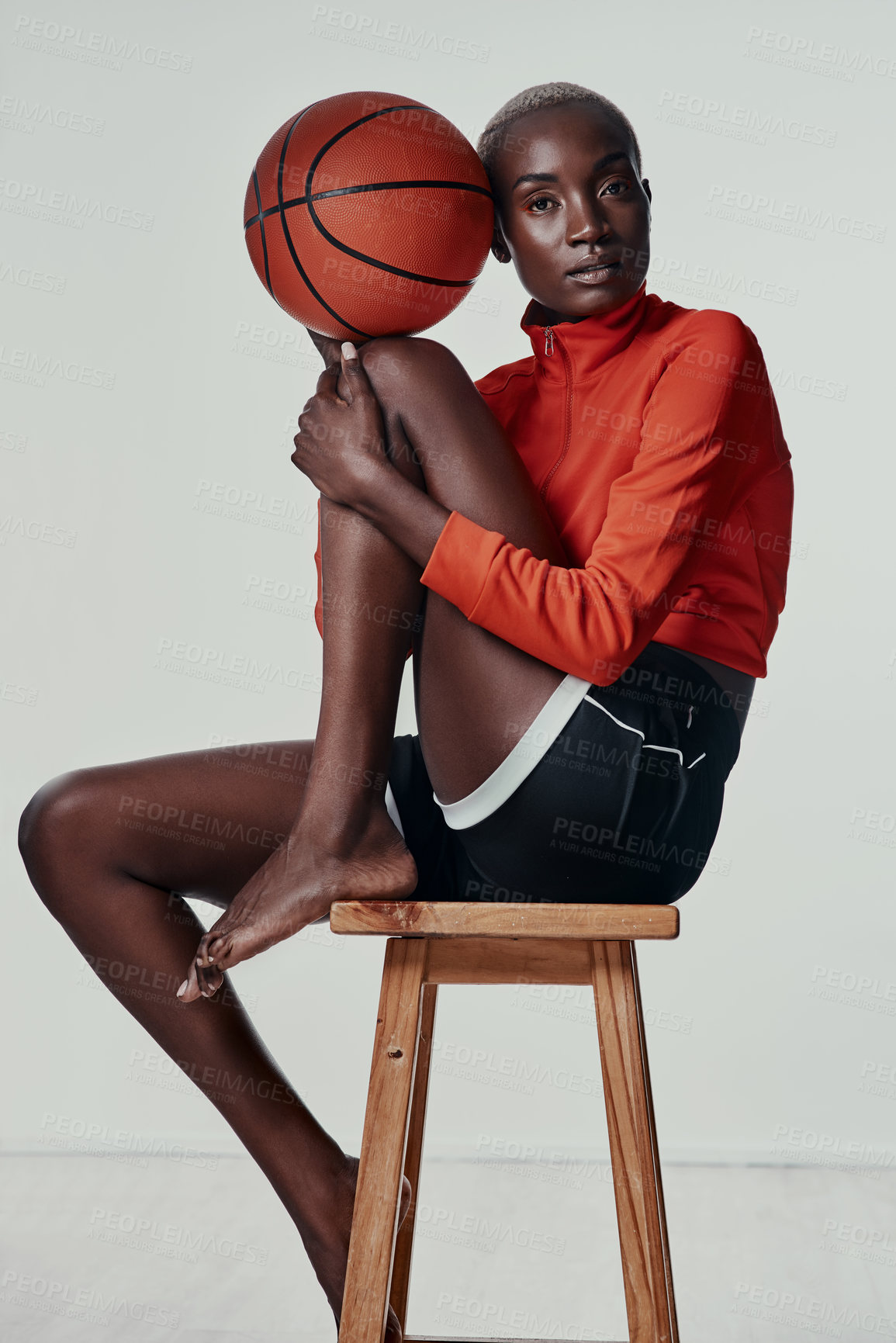 Buy stock photo Studio shot of an attractive young woman playing basketball against a grey background