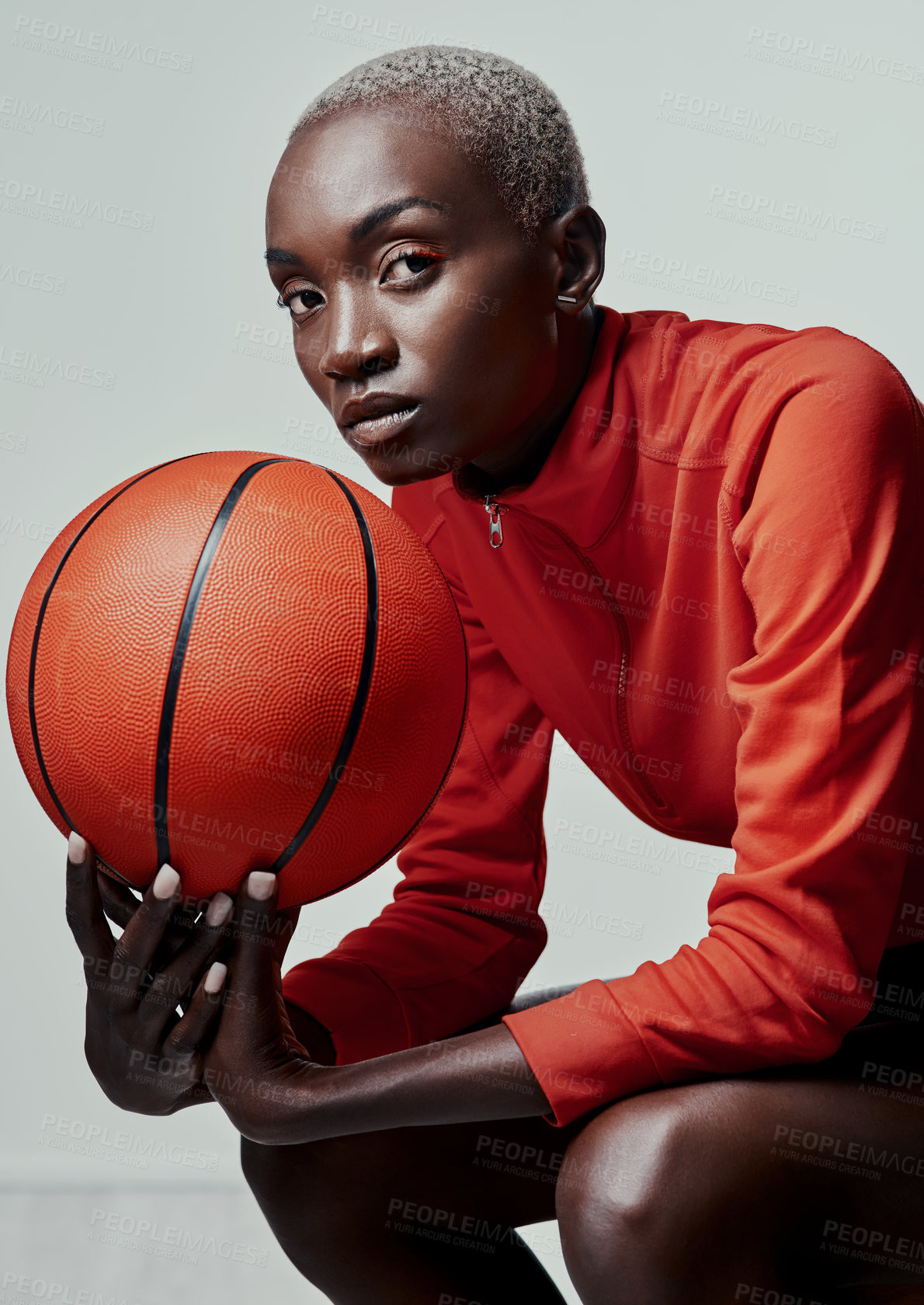 Buy stock photo Studio shot of an attractive young woman playing basketball against a grey background