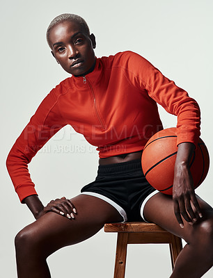 Buy stock photo Studio shot of an attractive young woman playing basketball against a grey background