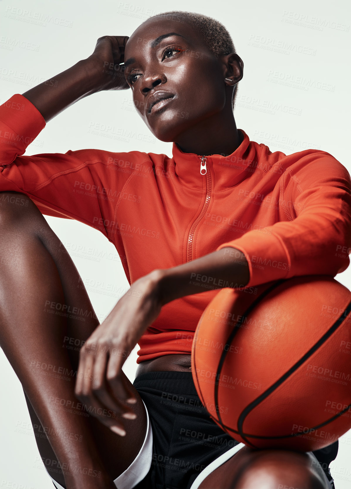 Buy stock photo Studio shot of an attractive young woman playing basketball against a grey background