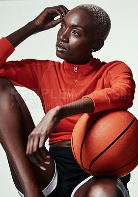 Buy stock photo Studio shot of an attractive young woman playing basketball against a grey background