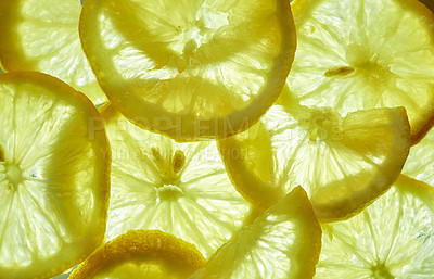 Buy stock photo Shot of a group of freshly cut lemon slices