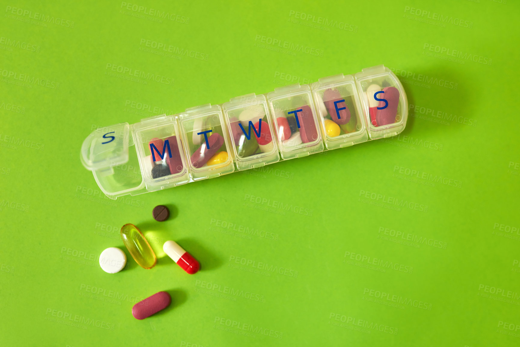 Buy stock photo Pills, medicine and daily container in studio with healthcare routine, medical reminder and prescription. Drugs, collection and tablets storage, management and treatment schedule on green background