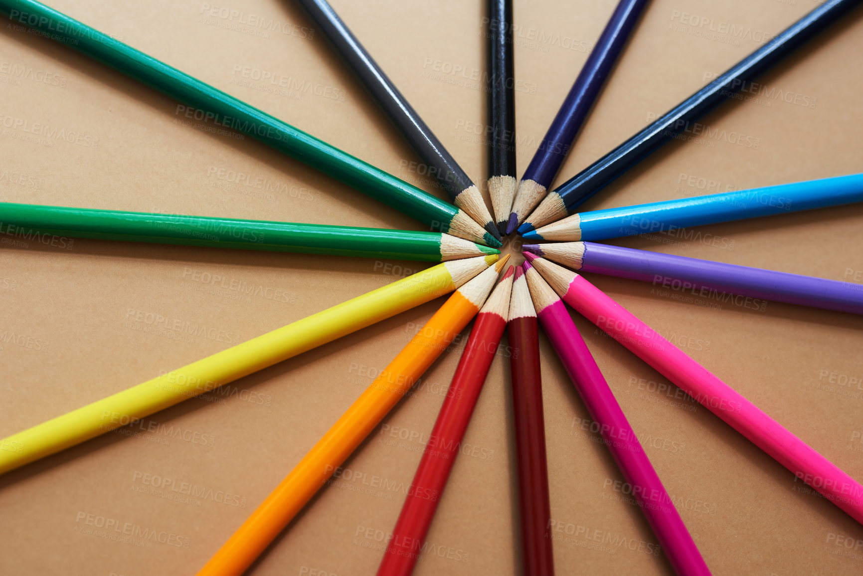 Buy stock photo Studio shot of different coloured pencils against a brown background
