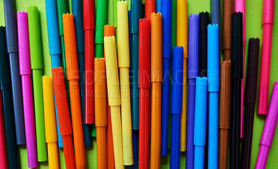 Buy stock photo Studio shot of different coloured felt tip pens against a green background