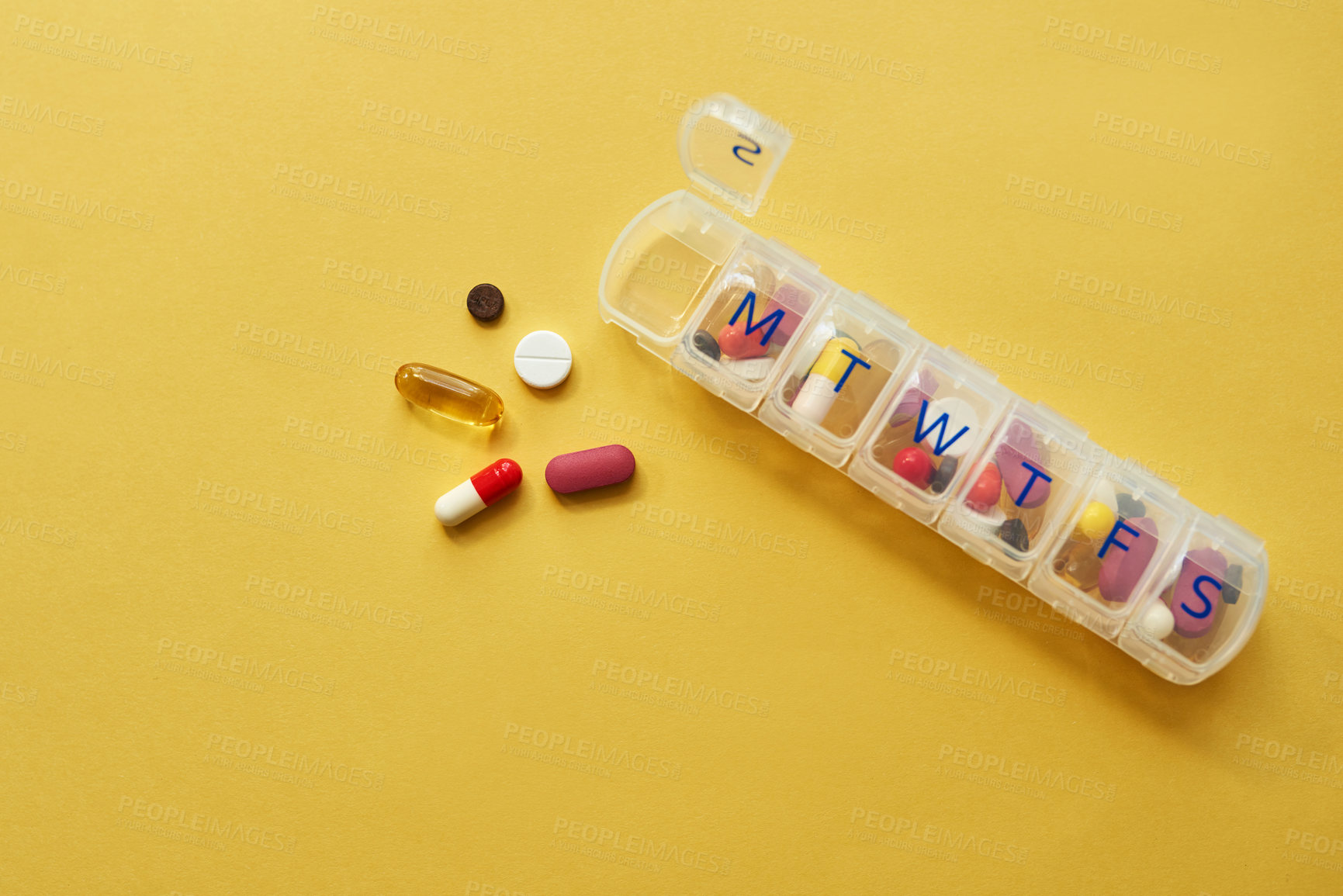 Buy stock photo Drugs, medicine and daily container in studio for healthcare routine, medical reminder and prescription. Pills, collection and tablets storage, management and treatment schedule on yellow background
