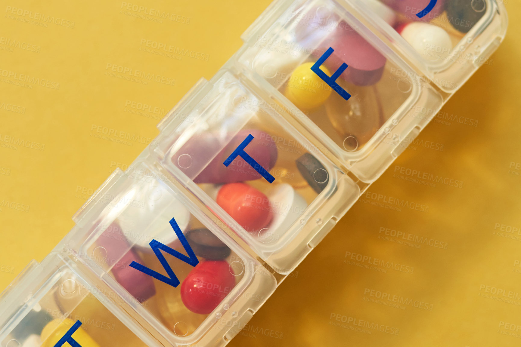 Buy stock photo Medicine, drugs and weekly container in studio for healthcare routine, medical reminder and prescription. Pills, closeup and tablets of storage, management and treatment schedule on yellow background