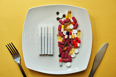 Buy stock photo Medicine, pills and meal with cigarettes in studio for healthy dinner, medical nutrition and prescription. Drugs, smoking and food for routine, healthcare addiction and treatment on yellow background