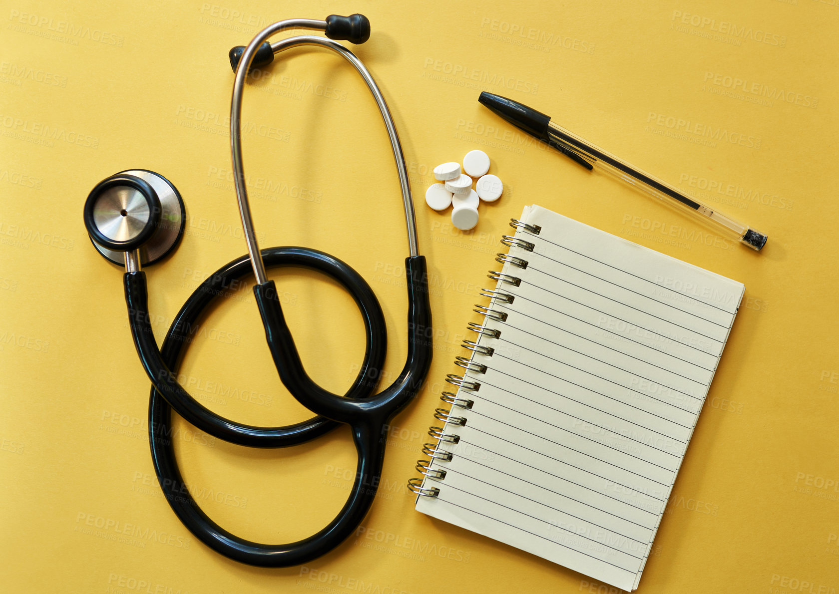 Buy stock photo Stethoscope, notebook and pen with pills in studio of medical diagnosis, medicine prescription and record. Healthcare, equipment and cardiology notes, treatment plan and drugs on yellow background