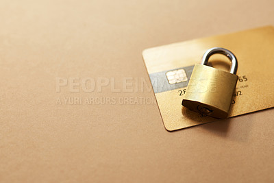 Buy stock photo Studio shot of a credit card and lock against a brown background