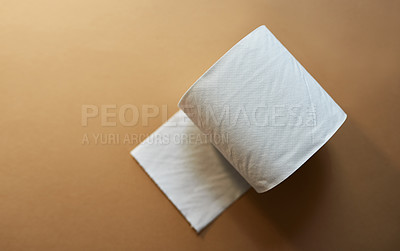 Buy stock photo Toilet paper, roll and brown background with soft sheet above for tissue, hygiene or restroom in studio. Top view, closeup and material with fabric for cleaning, wipe or essential equipment on space