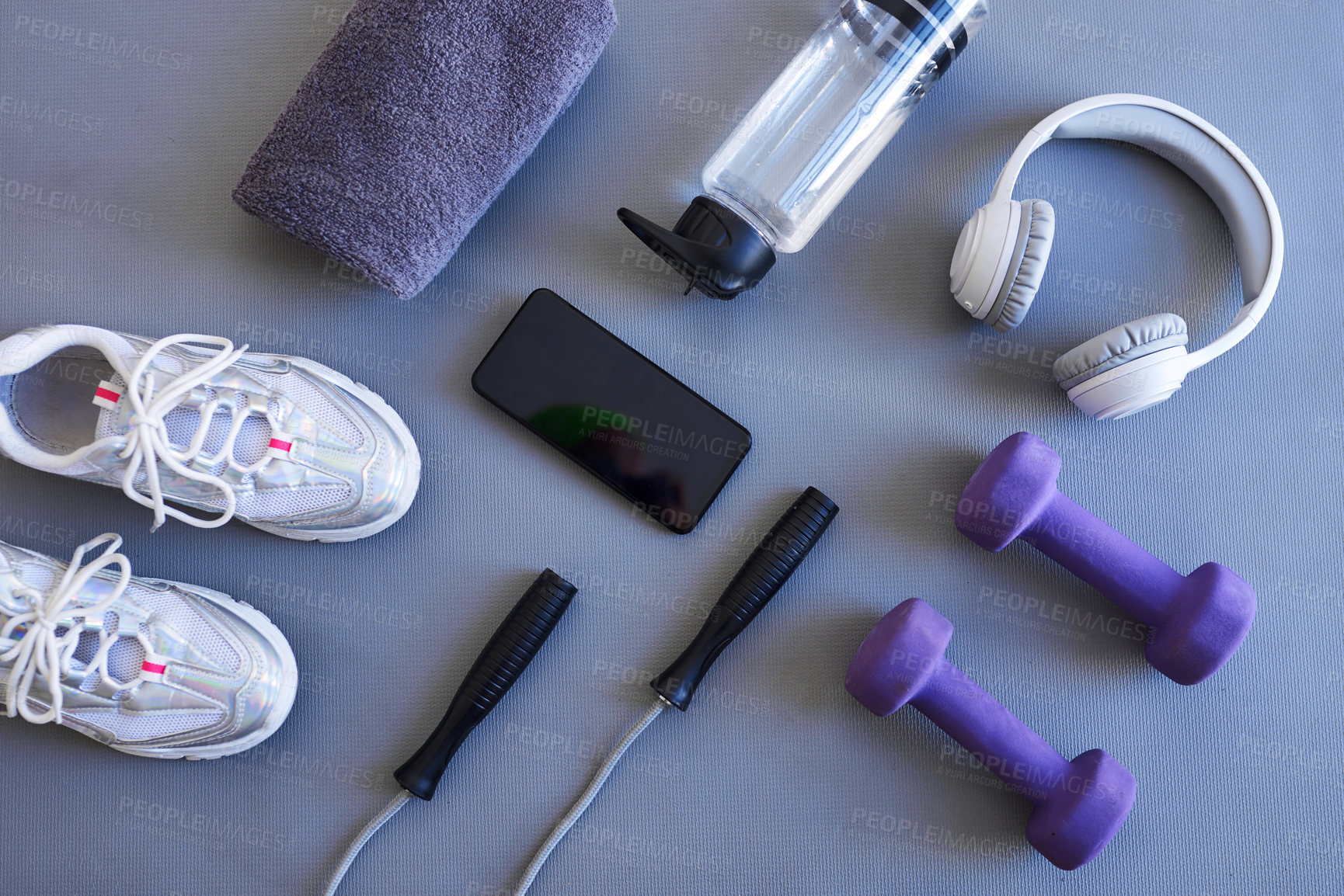 Buy stock photo Fitness, phone and sneakers with equipment for workout with water bottle in gym for health. Sneakers, headphones and top view of dumbbell weights and skipping rope for training in sports center.