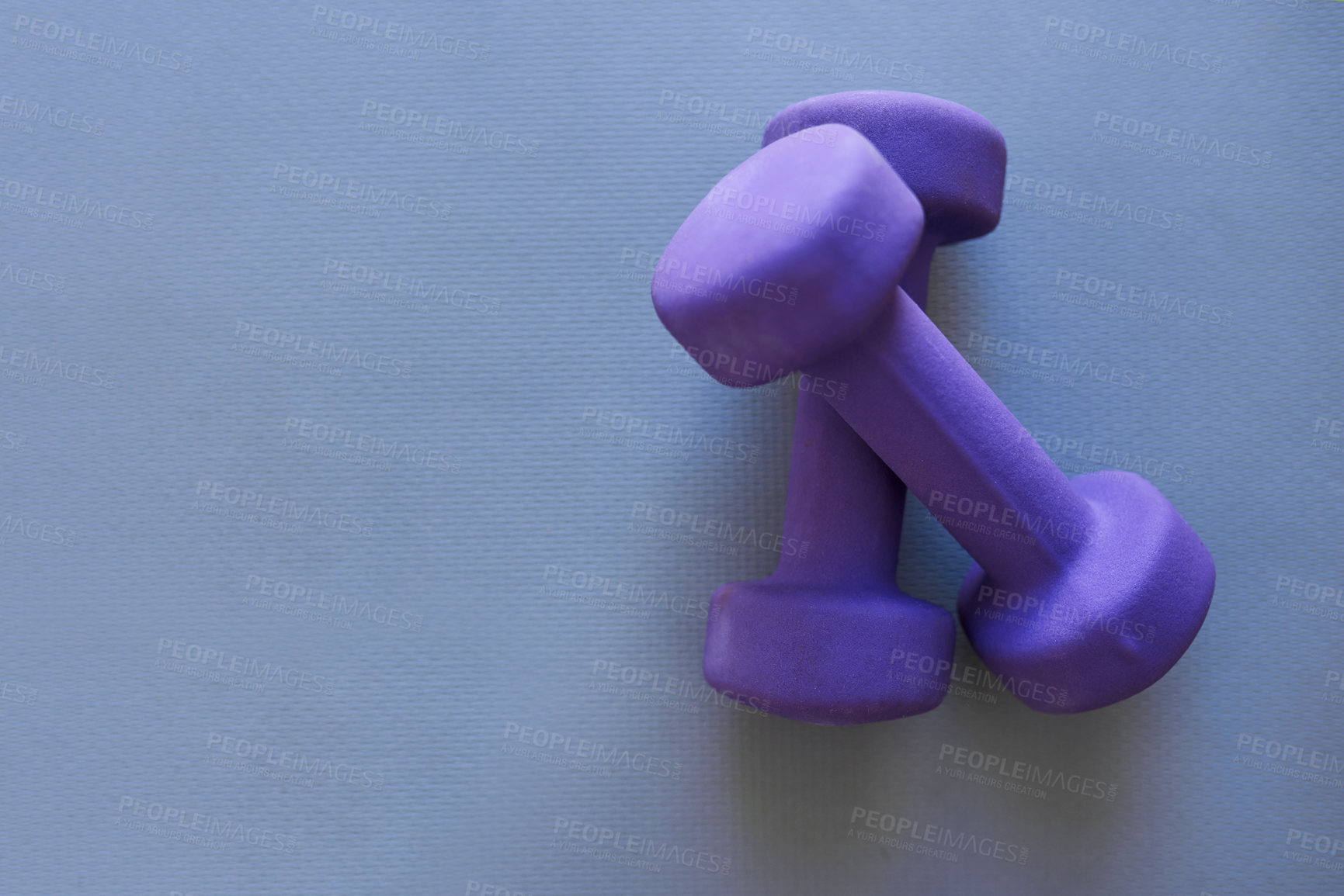 Buy stock photo Studio shot of two dumbbells against a grey background