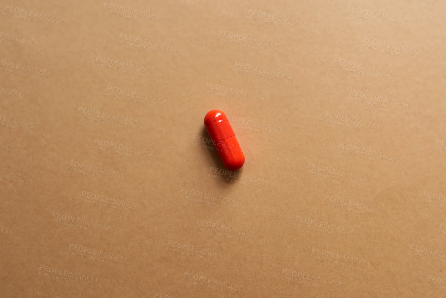 Buy stock photo Red, medicine and pills for health in studio with healthcare wellness, medical painkillers and prescription. Drugs, mockup space and addiction treatment, pain remedy and recovery on brown background