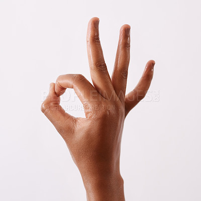 Buy stock photo Studio shot of an unrecognizable woman making an okay gesture against a white background
